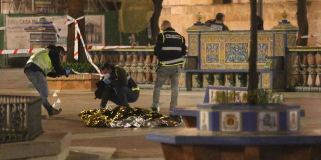 Police work next to the body of a man killed in Algeciras, southern Spain, on Jan. 25, 2023.