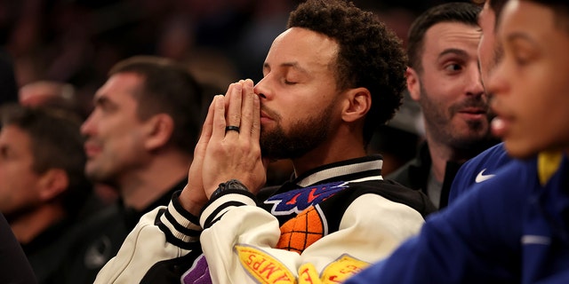 Stephen Curry #30 of the Golden State Warriors looks on from the bench during the second quarter of a game against the New York Knicks at Madison Square Garden on December 20, 2022 in New York City.