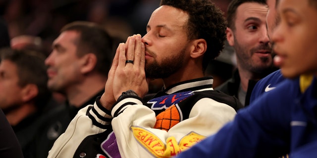Stephen Curry #30 of the Golden State Warriors looks on from the bench during the second quarter of the game against the New York Knicks at Madison Square Garden on December 20, 2022 in New York City.