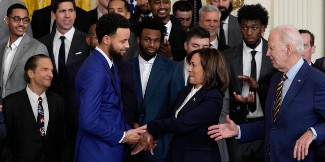 Vice President Kamala Harris shakes hands with 4-time NBA champion and 2-time NBA Most Valuable Player Stephen Curry while President Joe Biden shakes during an event for the 2022 NBA champion, Golden State, in the East Room of the White House .  Warriors, Tuesday, January 17, 2023, in Washington.