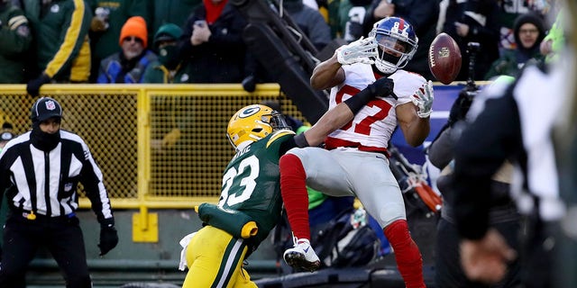 GREEN BAY, WI - JANUARY 8: Micah Hyde #33 of the Green Bay Packers breaks up a pass intended for Sterling Shepard #87 of the New York Giants in the first quarter during the NFC Wild Card game at Lambeau Field on January 8, 2017, in Green Bay, Wisconsin.