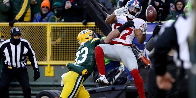 GREEN BAY, WI - JANUARY 8:  Micah Hyde #33 of the Green Bay Packers breaks up a pass intended for Sterling Shepard #87 of the New York Giants in the first quarter during the NFC Wild Card game at Lambeau Field on January 8, 2017, in Green Bay, Wisconsin.