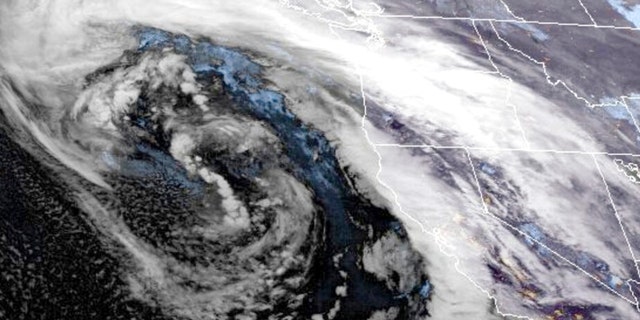This GOES-West GeoColor satellite image made available by NOAA shows a storm system approaching along the US West coast at 9:16 pm EST, on Wednesday, Jan.  4, 2023. As a huge storm approached California on Wednesday, officials began ordering evacuations in a high-risk coastal area where mudslides killed 23 people in 2018, while residents elsewhere in the state scrambled to find sandbags, and braced themselves for flooding and power outages 