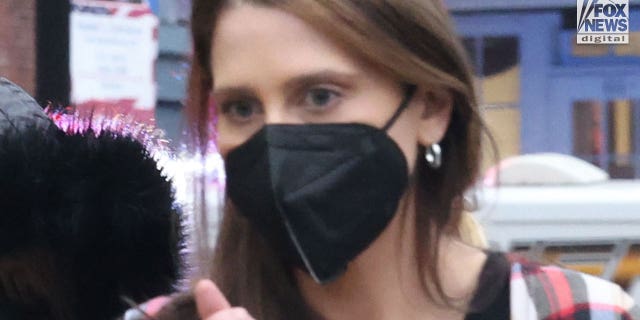 Woman in a plaid shirt and face mask