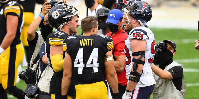 T.J. Watt, left, and Derek Watt of the Steelers talk to their brother J.J. Watt of the Houston Texans after their game at Heinz Field on Sept. 27, 2020, in Pittsburgh.