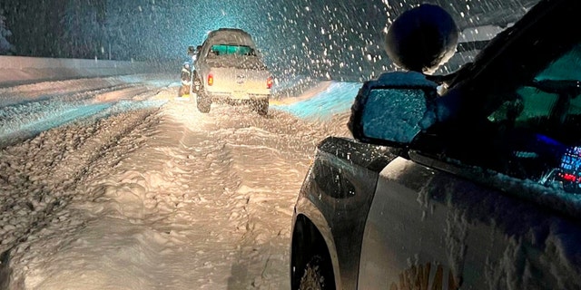 This image taken Saturday, Dec 31, 2022, and released by California Highway Patrol Truckee, vehicles stranded are stranded along Interstate 80 at the Nevada State line and Colfax, Calif.