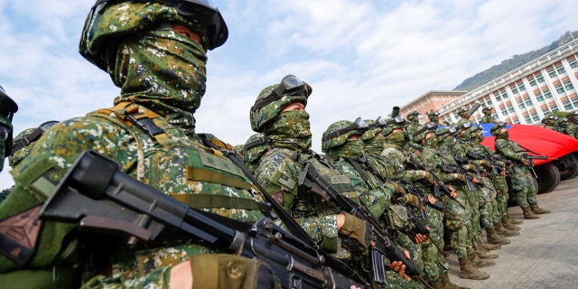 Soldiers stand guard after a preparedness enhancement drill simulating the defense against Beijing's military intrusions, ahead of the Lunar New Year in Kaohsiung City, Taiwan on Wednesday.
