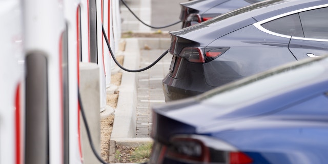 Tesla vehicles charge at a Tesla Supercharger station in Santa Monica, California, US, on Friday, Jan. 13, 2023. Tesla Inc. cut prices across its lineup in the US and major European markets in the carmakers latest effort to stoke demand after several quarters of disappointing deliveries. Photographer: Eric Thayer/Bloomberg