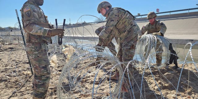 Texas National Guard installs razor wire along the border in an effort to stop immigrants from illegally crossing into the country from Mexico.