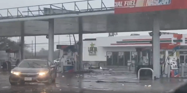 Part of a gas station roof is seen damaged in Deer Park, Texas, on Tuesday.