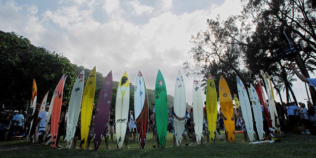 Participants line up their surf boards to pray during the In Memony of Eddie Aikau opening ceremony in Waimea Bay near Haleiwa, Hawaii, Nov. 30, 2006.