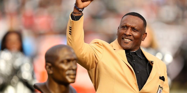 Former Oakland Raiders wide receiver Tim Brown is honored for his induction into the Pro Football Hall of Fame at halftime of an NFL game against the Kansas City Chiefs at O.co Coliseum in Oakland, CA.