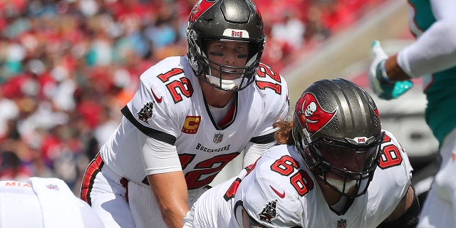 Buccaneers quarterback Tom Brady reviews the Dolphins defense on October 10, 2021 at Raymond James Stadium in Tampa, Florida.