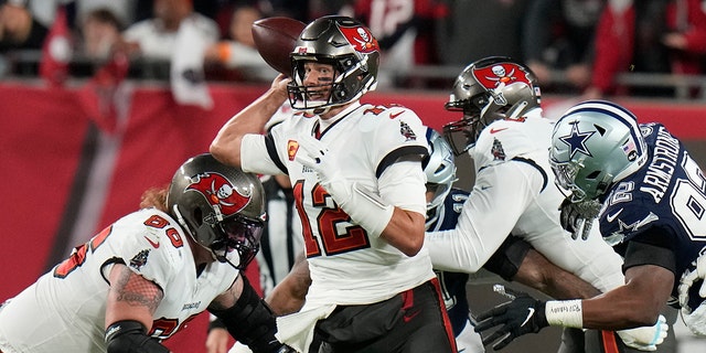 Tampa Bay Buccaneers quarterback Tom Brady (12) works under pressure against the Dallas Cowboys during the first half of an NFL Wild Card game Monday, Jan. 16, 2023, in Tampa, Florida.