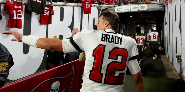 Tom Brady #12 of the Tampa Bay Buccaneers walks off the field after losing to the Dallas Cowboys 31-14 in the NFC Wild Card playoff game at Raymond James Stadium on January 16, 2023 in Tampa, Florida.