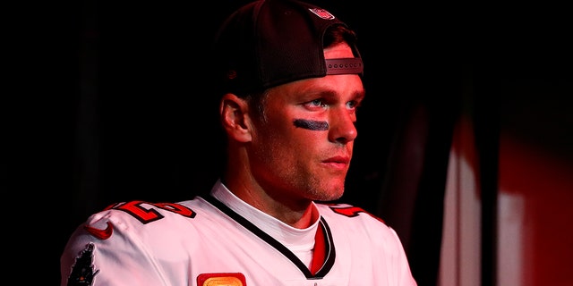 Tom Brady of the Buccaneers walks through the tunnel at Raymond James Stadium before the wild card game against the Dallas Cowboys on January 16, 2023 in Tampa, Florida.