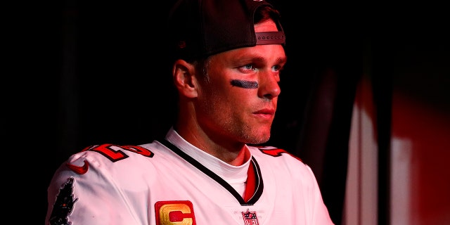 Tom Brady of the Buccaneers walks through the tunnel at Raymond James Stadium before the wild-card game against the Dallas Cowboys on Jan. 16, 2023, in Tampa, Florida.