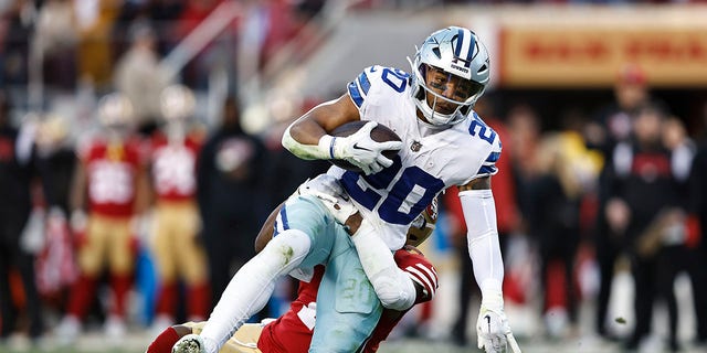 Tony Pollard (20) of the Dallas Cowboys is tackled by Jimmie Ward of the San Francisco 49ers and gets injured during an NFL divisional round playoff game at Levi's Stadium Jan. 22, 2023, in Santa Clara, Calif.