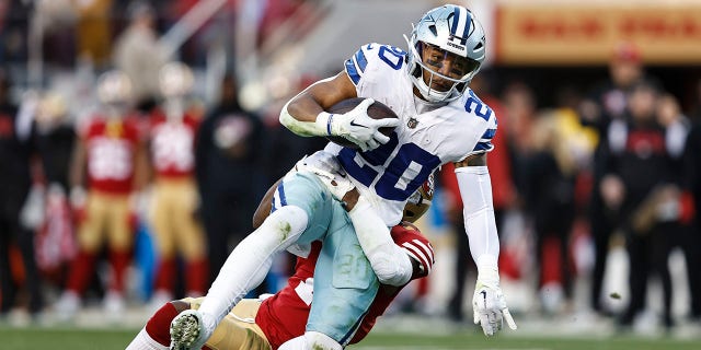 Tony Pollard (20) of the Dallas Cowboys is tackled by Jimmie Ward of the San Francisco 49ers and gets injured during an NFL divisional round playoff game at Levi's Stadium Jan. 22, 2023, in Santa Clara, Calif.