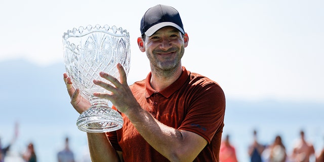 Former NFL football player Tony Romo kisses the cup after winning the American Century Championship at Edgewood Tahoe Golf Course on July 10, 2022 in Stateline, Nevada.