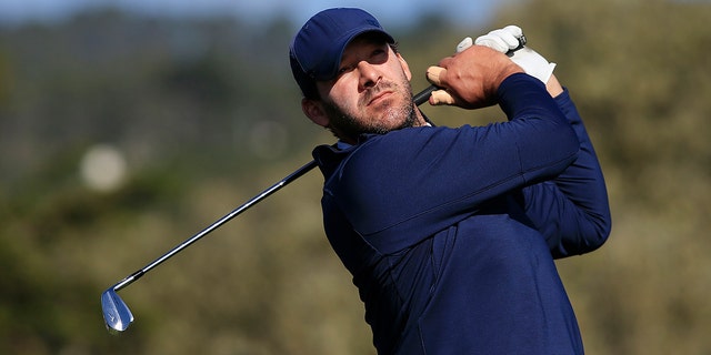 Former NFL player Tony Romo plays his shot from the 17th tee during the third round of the AT&T Pebble Beach Pro-Am at Pebble Beach Golf Links on Feb. 8, 2020 in Pebble Beach, California.