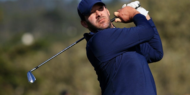 Former NFL player Tony Romo plays his shot from the 17th tee during the third round of the AT&T Pebble Beach Pro-Am at Pebble Beach Golf Links on Feb. 8, 2020 in Pebble Beach, California.