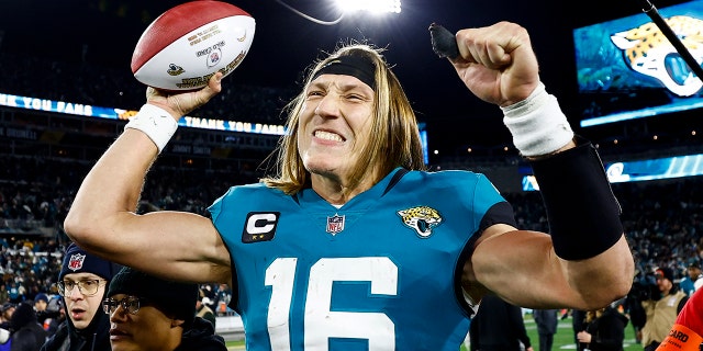 Trevor Lawrence of the Jacksonville Jaguars celebrates after beating the Los Angeles Chargers in an NFL wild-card playoff football game at TIAA Bank Field Jan. 14, 2023, in Jacksonville, Fla.