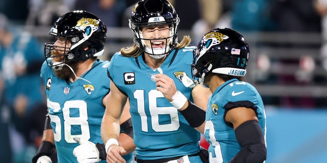 Trevor Lawrence #16 of the Jacksonville Jaguars celebrates with Christian Kirk #13 of the Jacksonville Jaguars after Kirk's receiving touchdown during the second quarter against the Tennessee Titans at TIAA Bank Field on January 7, 2023 in Jacksonville, Florida.