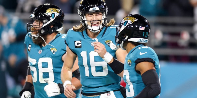 Trevor Lawrence #16 of the Jacksonville Jaguars celebrates with Christian Kirk #13 of the Jacksonville Jaguars after Kirk's receiving touchdown during the second quarter against the Tennessee Titans at TIAA Bank Field on January 7, 2023 in Jacksonville, Florida.