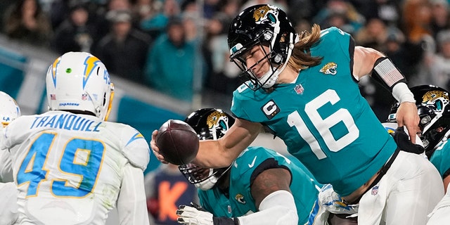 Jaguars quarterback Trevor Lawrence leaps for a two-point conversion against the Los Angeles Chargers during the NFL wild-card football game, Saturday, Jan. 14, 2023, in Jacksonville, Florida.