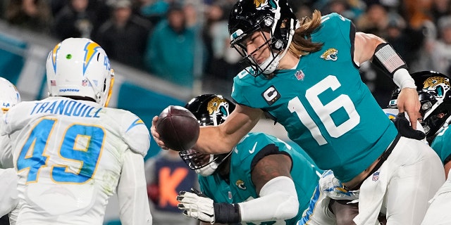 Jaguars quarterback Trevor Lawrence leaps for a two-point conversion against the Los Angeles Chargers during the NFL wild-card football game, Saturday, Jan. 14, 2023, in Jacksonville, Florida.