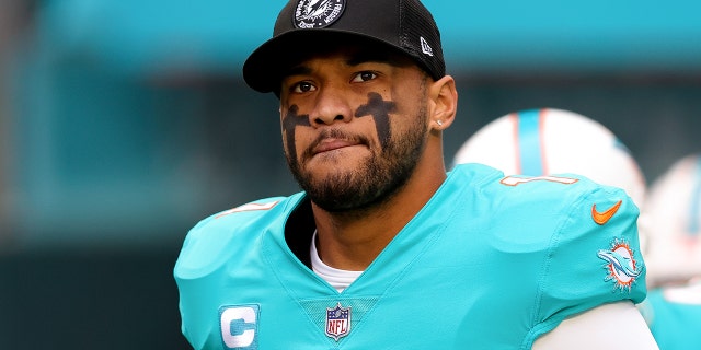 Tua Tagovailoa #1 of the Miami Dolphins jumps onto the field before a game against the Green Bay Packers at Hard Rock Stadium on December 25, 2022 in Miami Gardens, Florida. 