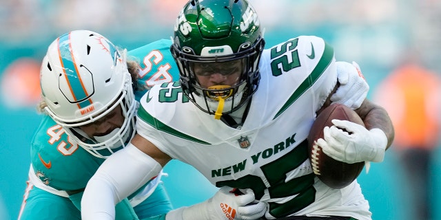 Miami Dolphins linebacker Duke Riley (45) tackles New York Jets running back Ty Johnson (25) during the first half of an NFL football game, Sunday, Jan. 8, 2023, in Miami Gardens, Florida.