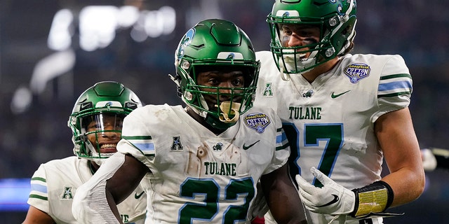 Tulane running back Tyjae Spears (22) celebrates after scoring a touchdown during the first half of the Cotton Bowl NCAA college football game against Southern California, Monday, Jan. 2, 2023, in Arlington, Texas. 