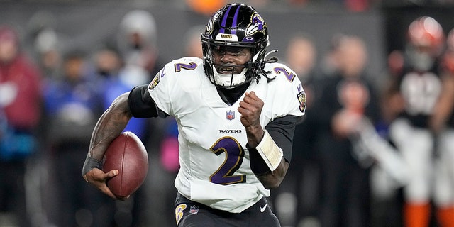 Baltimore Ravens quarterback Tyler Huntley runs with the ball in the first half of an NFL wild-card playoff football game against the Cincinnati Bengals in Cincinnati, Sunday, Jan. 15, 2023.