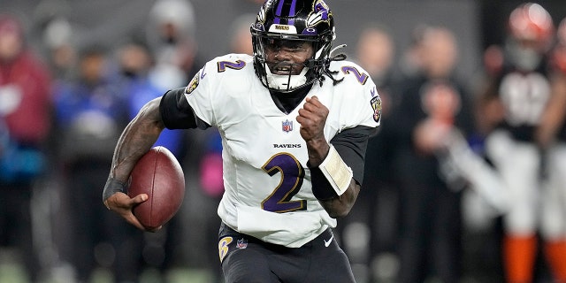 Baltimore Ravens quarterback Tyler Huntley runs with the ball in the first half of an NFL wild-card playoff football game against the Cincinnati Bengals in Cincinnati, Sunday, Jan. 15, 2023.