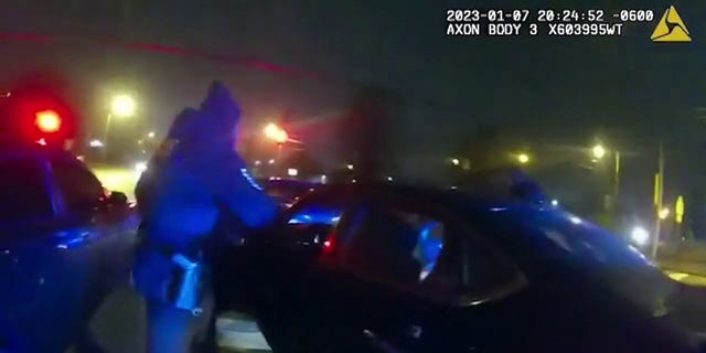 A Memphis police officer pulling Tyre Nichols out of his vehicle on Jan. 7, 2023.