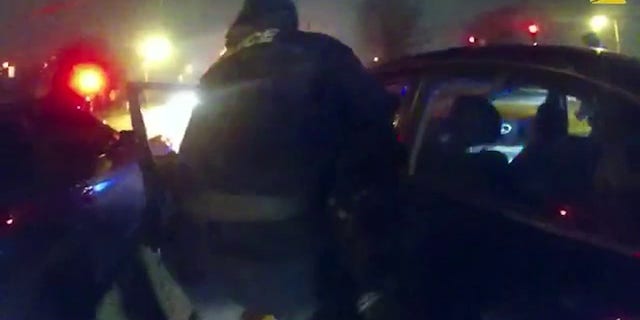 Several Memphis police officers attempt to remove Tire Nichols from his vehicle on January 7, 2023.