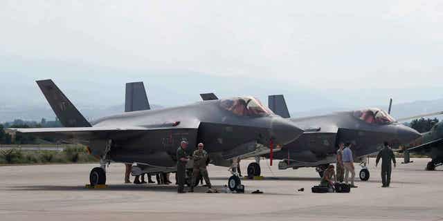  U.S. military personnel work near the F-35 fighter jet of the Vermont Air National Guard, parked in the military base at Skopje Airport, North Macedonia, on June 17, 2022. On Jan. 4, 2023, the Czech Republic's government approved legislation to make it mandatory for the country's defense spending to meet a goal of 2% of GDP amid the Russian war against Ukraine. 