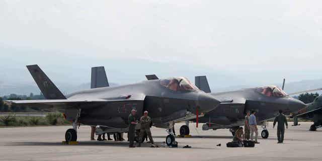  U.S. military personnel work near the F-35 fighter jet of the Vermont Air National Guard, parked in the military base at Skopje Airport, North Macedonia, on June 17, 2022. On Jan. 4, 2023, the Czech Republic's government approved legislation to make it mandatory for the country's defense spending to meet a goal of 2% of GDP amid the Russian war against Ukraine. 