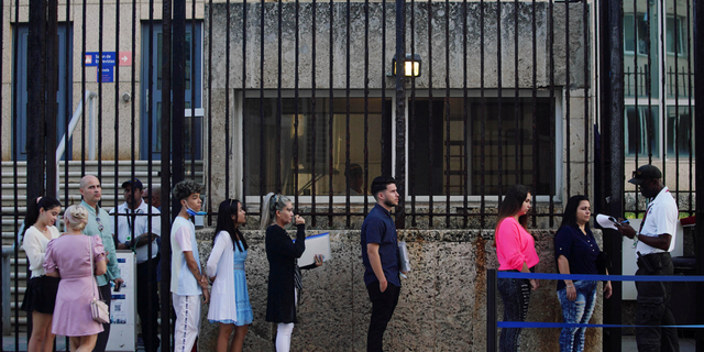 People wait in line to enter the U.S. embassy in Havana, Cuba, on Jan. 4, 2023. 