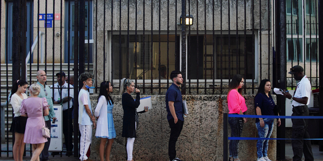 People wait in line to enter the U.S. embassy in Havana, Cuba, on Jan. 4, 2023. 