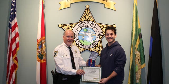 Florida Bartender David Ghiloni receives award from Flagler County Sheriff's Deparment.
