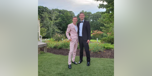 Zachary Zulock and William Zulock standing at a wedding.
