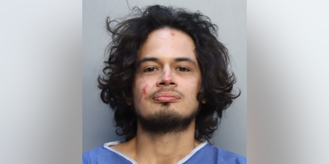 After multiple commands open the door, police kicked it in when they heard a woman scream inside the apartment. The man, Kevin Mayorga, 32, hid behind a door when officers entered the apartment.