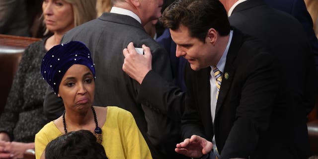 Congressman-elect Matt Gaetz, R-Fla., and Congresswoman-elect Ilhan Omar, D-Minn., a member of the "Squad," chat in the House chamber during the third day of elections for speaker of the house.