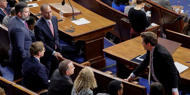 Congressman-elect Matt Gaetz, R-Fla., talks to House Democratic Leader Hakeem Jeffries of New York and other Democrats in the House chamber Thursday.