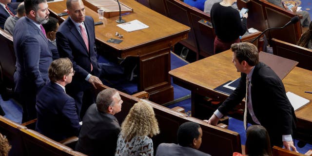 Congressman-elect Matt Gaetz, R-Fla., talks to House Democratic Leader Hakeem Jeffries of New York and other Democrats in the House chamber Thursday.