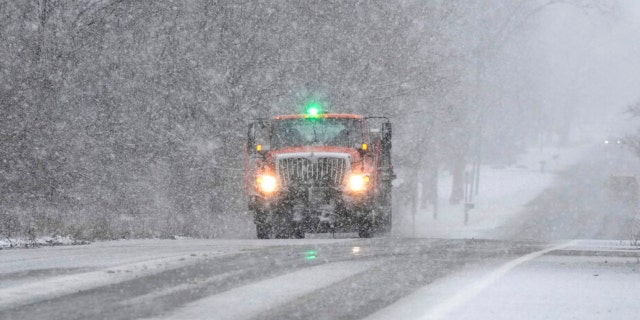 A Wayne County Department of Public Services truck salts a road, Wednesday, Jan. 25, 2023, in Wayne, Michigan.