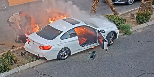 A Las Vegas police officer and a good Samaritan helped pull a driver from a fiery car wreck on Friday